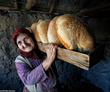 18963638-7507883-food-category-winner-an-elderly-woman-carries-a-basket-of-bread--a-55-1569514368587.jpg